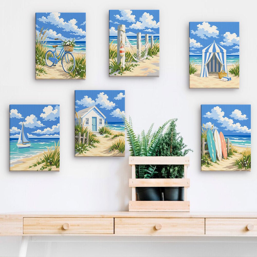 Beach Cottages mini paintings displayed on a wall