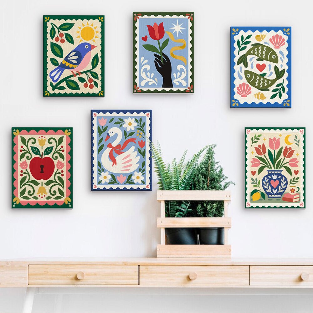 Folk Art Stamps mini paintings displayed on a wall