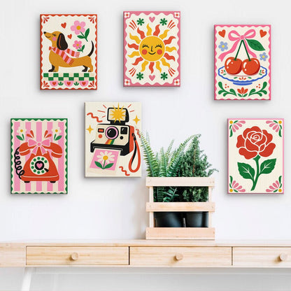 Kitsch Classics mini paintings displayed on a wall