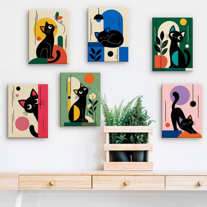 Mid-Century Cats mini paintings displayed on a wall