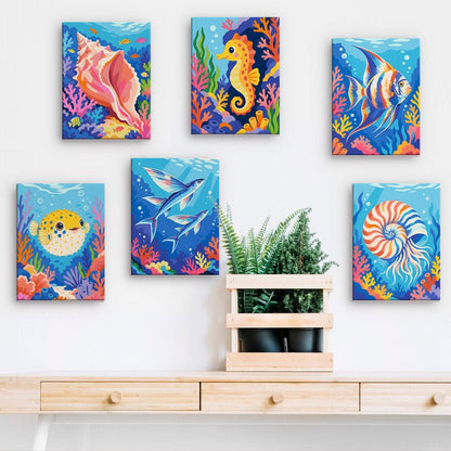 Ocean Wonders mini paintings displayed on a wall