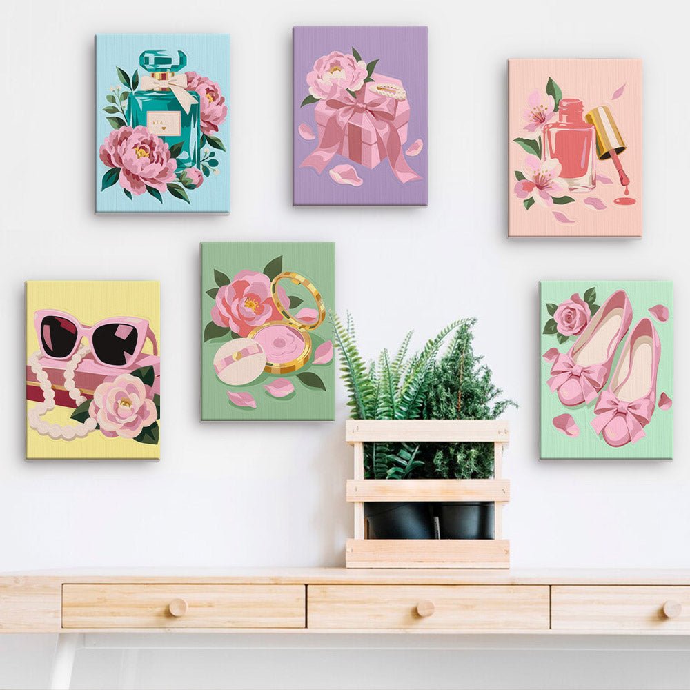 Pink Glam Essentials mini paintings displayed on a wall