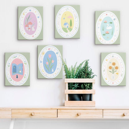 Storybook Cameos mini paintings displayed on a wall